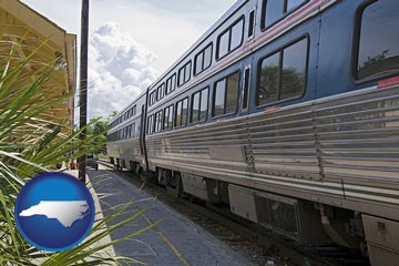 a passenger train at a railroad station - with North Carolina icon